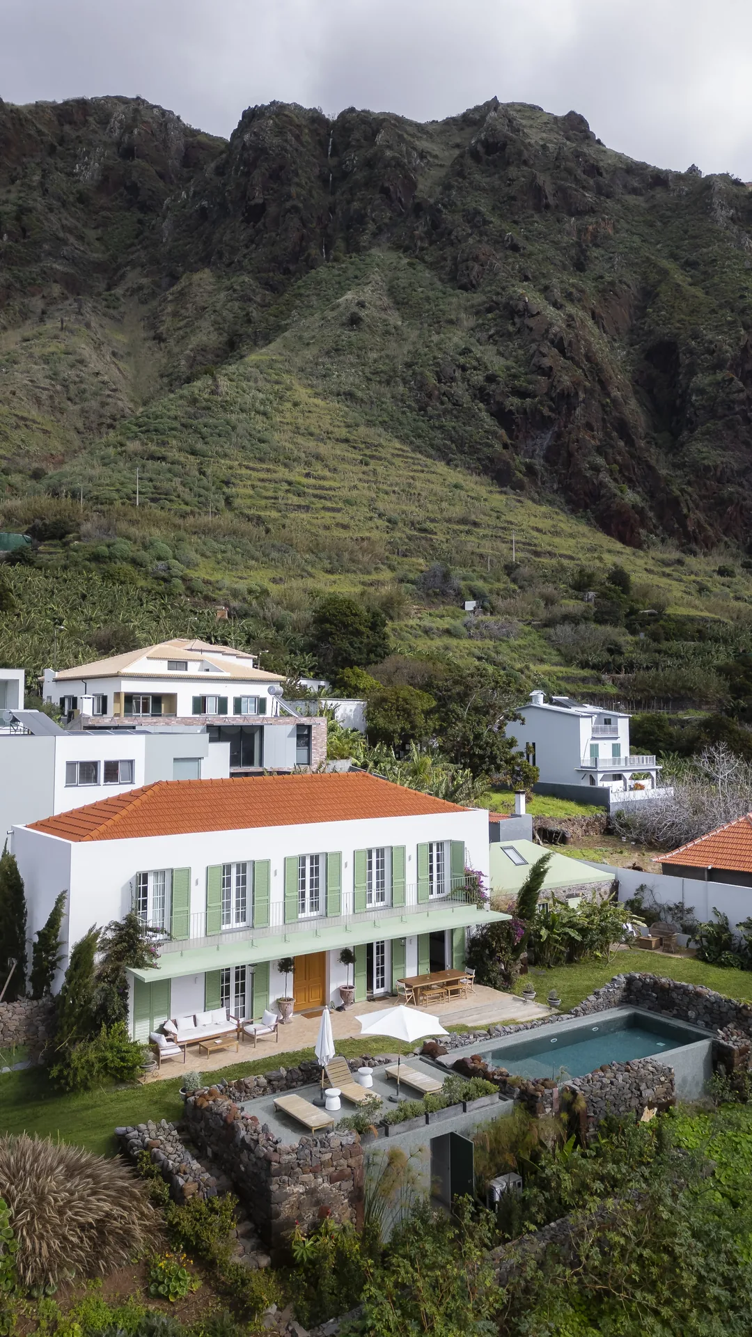 A Casa no Paul do Mar com a piscina e a encosta em fundo.